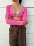 Meshki Ribbed Long Sleeve Twist Front Crop Top Pink - Image 1